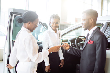 young african woman surprised by new car, gift for my beautiful wife