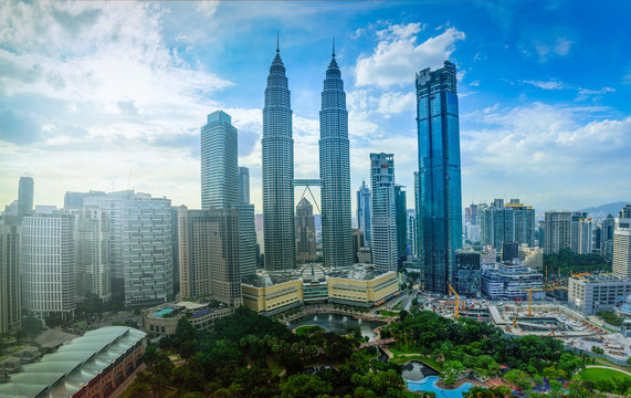 Cityscape of Kuala lumpur city skyline on blue sky with sunlight in Malaysia at daytime.
