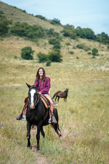 beautiful young girl riding a horse