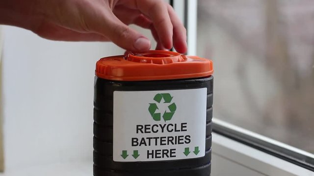 A recycling bin for used batteries. The three chasing arrows of the international recycling logo