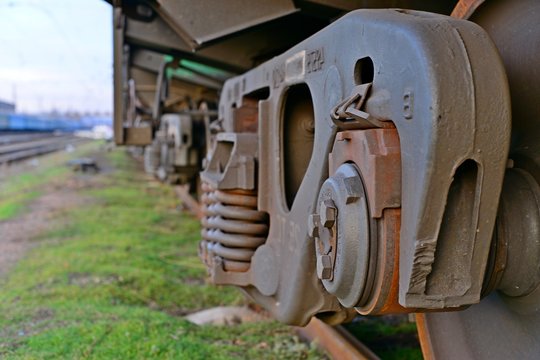 Close-ups Steel diesel railcar train bogie wheels on the tracks.