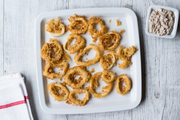 Fried Crispy Calamari Squid Rings with Tartar Sauce and Lemon.