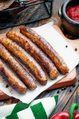 Pork chipolata. Close-up view of fried sausages. Meat dish