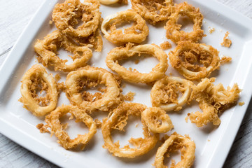 Fried Crispy Calamari Squid Rings with Tartar Sauce and Lemon.