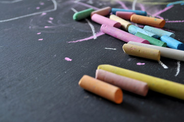 Blackboard with colored chalks