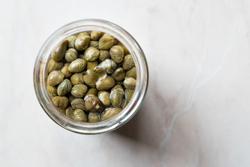 Jar of Capers in Glass Bowl.