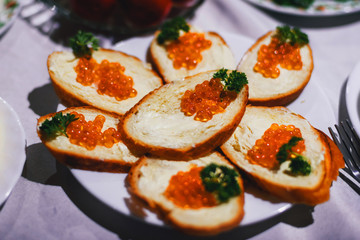 sandwiches with red caviar fish and butter and parsley. Traditional Russian delicacy for a luxurious celebration