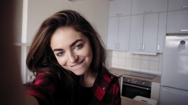 Young attarctive sexy girl recording a video of herself. Selfie video.