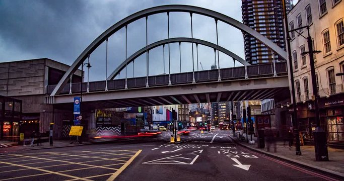 Time lapse view of car traffic and commuters in Shoreditch, at the entrance of the City of London, at sunset
