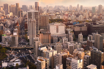 Fototapeta na wymiar Cityscapes of Tokyo sunset, city aerial skyscraper view of office building and downtown and street of minato in tokyo with yellow sunlight background. Japan, Asia