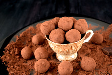 Chocolate truffles covered with cacao in a ceramic cup