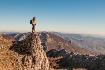 A happy traveler on a mountain top