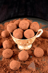 Chocolate truffles covered with cacao in a ceramic cup