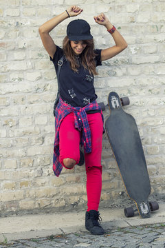Young urban girl with skate board smile