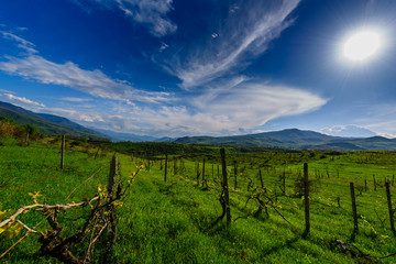 Fototapeta na wymiar Amazing spring skyscape with beautiful clouds and green field, Armenia