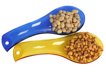 Nuts and seed for eating in spoon on white background