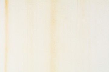 water and rust stain on a white concrete wall