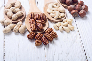 Mix of nuts in wooden spoon