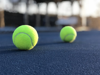 Tennis Balls By Net On Blue Tennis Court Low Angle