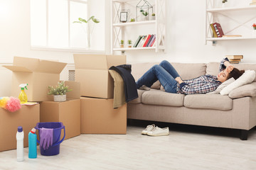 Tired woman having rest after cleaning home