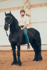 man riding brown horse on the countryside