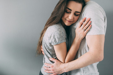 A photo session of a guy and a girl in a cozy home environment.