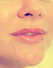Naklejka premium Close-up of woman's lips with natural lipstick make up. macro lipgloss make-up