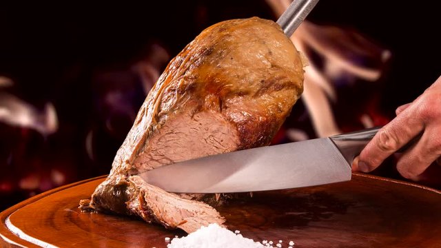 Cupim roasted, traditional Brazilian barbecue with fire background.
