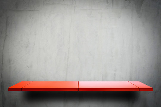 Empty Red Metal Display Shelf On Grungy Cement Wall