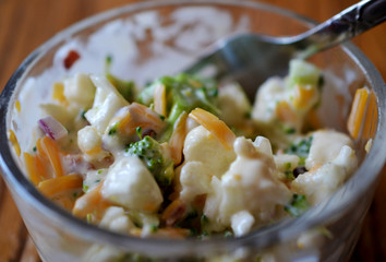 Broccoli Salad in glass bowl close up
