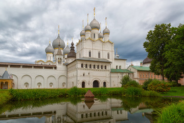 Fototapeta na wymiar One of temples of the Rostov Kremlin is reflected in a pond