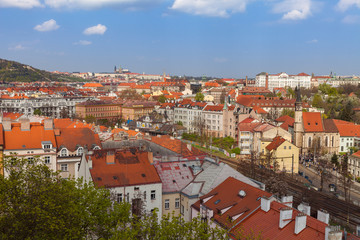 Fototapeta na wymiar Prague skyline with castle and living blocks red rooftops with park and trees