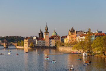 Obraz premium Old town of Prague, Czech Republic, summer season. View on the river Vltava with boats and happy tourists