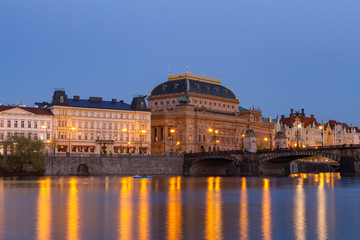 Evening view of illuminated embankment and the National theatre. Prague, Czech Republic