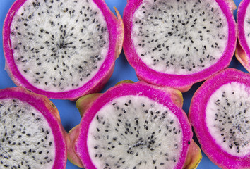 Pitaya slices over blue background