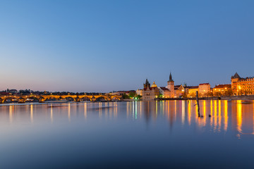 Scenic summer evening view of the Old Town ancient architecture and the Charles bridge over Vltava river in Prague, Czech Republic