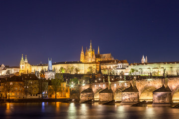 Amazing night view of Hradcany (Prague Castle) with St. Vitus Cathedral and Charles bridge at night, Bohemia landmark. Prague, Czech Republic.