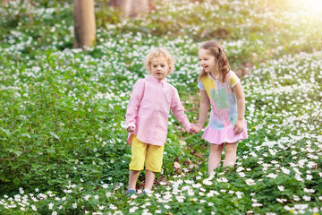 Children in spring park with flowers