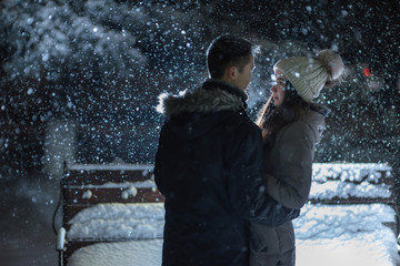 Night photo of lovers under the snow