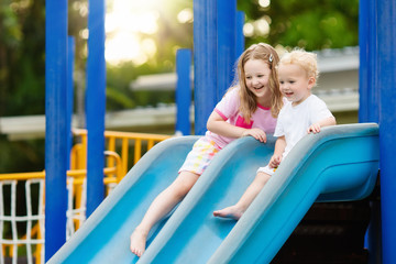Fototapeta na wymiar Kids on playground. Children play in summer park.