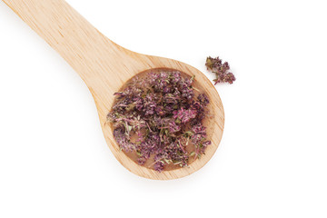 Dried thyme herbs in wooden spoon isolated on white background, top view.