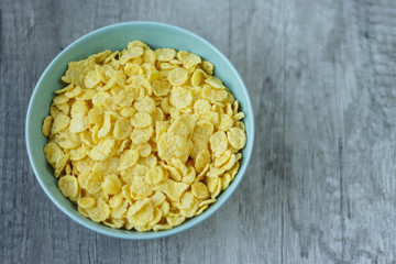 flakes lie on a plate that stands on a table, breakfast
