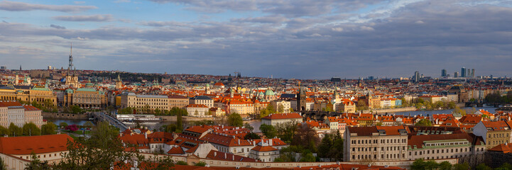 Sunset view of old town skyline with bridges and Vltava river from Hradcany castle. Skyline of Prague, Czech Republic. Wide panorama.