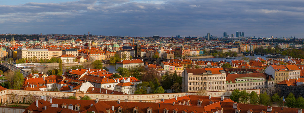 Bright sunset panoramic view of old town skyline with bridges and Vltava river from Hradcany castle. Skyline of Prague, Czech Republic
