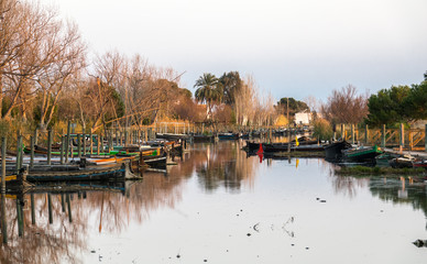 Fototapeta premium Catarroja Valencia Spain several traditional wooden boats on the mooring dock. harbor of the Albufera nature reserve,