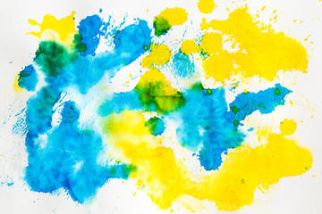 Watercolor blue and yellow abstract background. Hand made splashes on watercolor grainy textured paper.