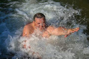 A man will swim in a seething stream of water