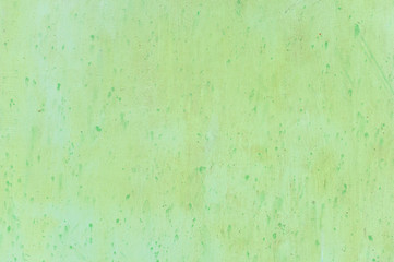 Textured metal surface carelessly colored green paint and faded in the sun in pale gray with rusty...