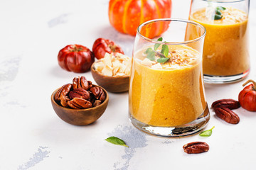 Pumpkin smoothie with coconut chips, pecan nuts, cinnamon and mint