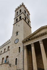 Fototapeta na wymiar The tower with the clock on the main square of Assisi, Umbria, Italy